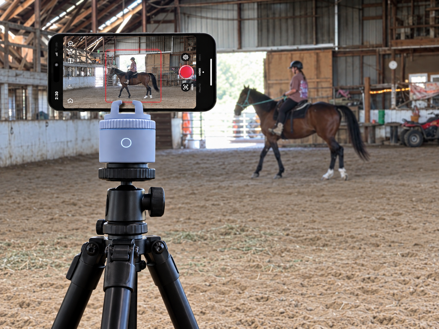 Pivo Pod on a tripod recording a horse and rider during training in a large indoor arena